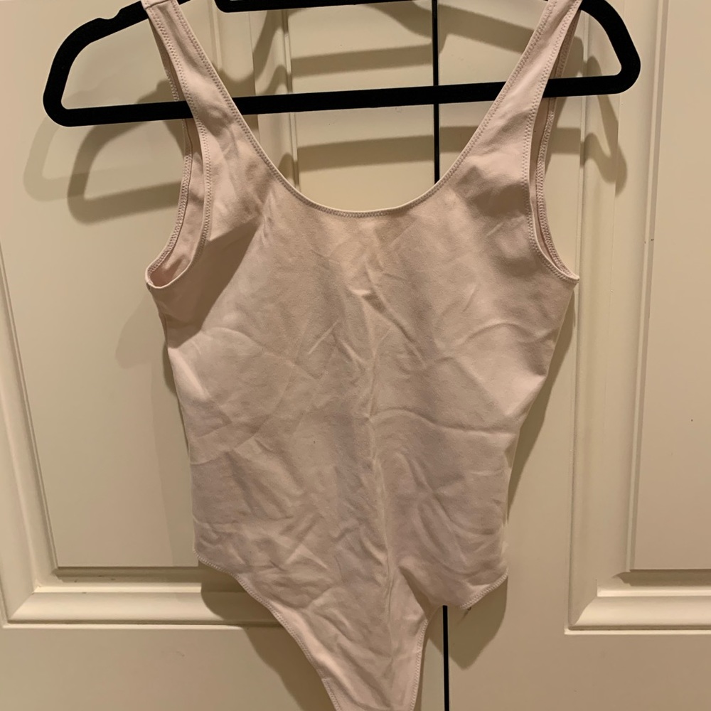 ARITZIA PALE PINK BODY SUIT. NEVER WORN.